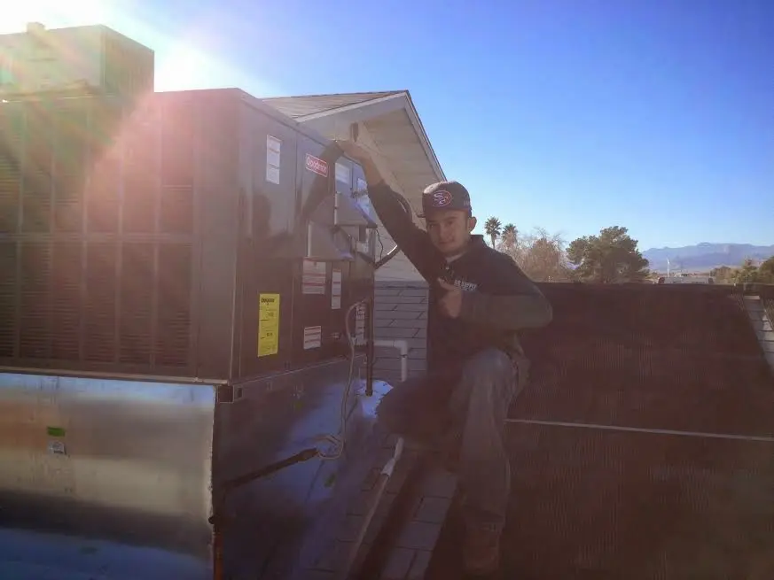 HVAC technician performing Air Duct Repair on a rooftop unit in Jacksonville